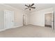 Bedroom featuring carpet, neutral walls, ceiling fan, and paneled doors at 87 Tee Dr, Selma, NC 27576