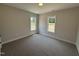 Bedroom with neutral walls, carpeted floors, and dual windows at 87 Tee Dr, Selma, NC 27576