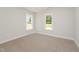 This bright bedroom offers two windows, carpeted floors, and neutral walls at 87 Tee Dr, Selma, NC 27576