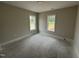 Unfinished bedroom with two large windows allowing ample natural light at 87 Tee Dr, Selma, NC 27576
