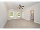 Bedroom featuring carpet, neutral walls, ceiling fan, and ensuite bathroom at 87 Tee Dr, Selma, NC 27576