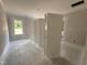 Empty bedroom with bare concrete flooring and large window offering natural light at 87 Tee Dr, Selma, NC 27576