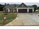 Inviting new construction home with a three-car garage and neatly sodded front lawn at 87 Tee Dr, Selma, NC 27576