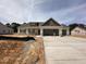 New construction home with attached three car garage and modern design elements at 87 Tee Dr, Selma, NC 27576