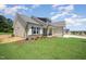 Well-manicured lawn and landscaping accentuate this charming home's side exterior and attached garage at 87 Tee Dr, Selma, NC 27576