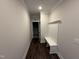 Hallway with hardwood flooring and a built-in bench at 87 Tee Dr, Selma, NC 27576
