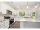 Modern kitchen featuring granite countertops, stainless steel appliances, and white cabinetry at 87 Tee Dr, Selma, NC 27576
