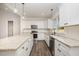 Bright kitchen featuring white cabinets, granite countertops, and stainless steel appliances at 87 Tee Dr, Selma, NC 27576