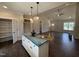 Kitchen with an island and pendant lights, open to the living room, and featuring modern appliances and countertops at 87 Tee Dr, Selma, NC 27576