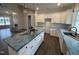 Modern kitchen with white cabinets, an island with a dark base, and lots of natural light at 87 Tee Dr, Selma, NC 27576