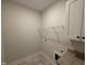 Laundry room with tile floor, storage cabinet, and washer/dryer hookups at 87 Tee Dr, Selma, NC 27576