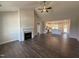 Open-concept living room featuring a fireplace with stone trim and hardwood floors at 87 Tee Dr, Selma, NC 27576
