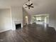 Spacious living room with a fireplace, vaulted ceiling, and hardwood floors at 87 Tee Dr, Selma, NC 27576