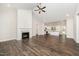 Open-concept living room with a fireplace, high ceilings, and hardwood floors, perfect for entertaining at 87 Tee Dr, Selma, NC 27576