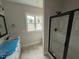 A main bathroom featuring double sinks and a modern, glass enclosed shower at 87 Tee Dr, Selma, NC 27576