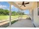 This screened porch provides shade with a ceiling fan and views of the backyard at 87 Tee Dr, Selma, NC 27576