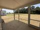 Enjoy the outdoors bug-free from this screened porch overlooking a spacious backyard lawn and wooded area at 87 Tee Dr, Selma, NC 27576