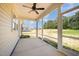 This screened porch offers an overhead fan and views of the large backyard at 87 Tee Dr, Selma, NC 27576