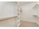 Spacious walk-in closet with built-in shelving and carpet flooring at 87 Tee Dr, Selma, NC 27576