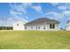 Back exterior view of the house with ample yard space and additional building on the property at 89 W Emily Gardens Dr, Selma, NC 27576