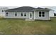 Newly seeded backyard featuring vinyl siding, a glass door, and several windows for natural light at 89 W Emily Gardens Dr, Selma, NC 27576