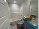 Bathroom with a shower-tub combo and single sink vanity, offering essential features for personal care at 89 W Emily Gardens Dr, Selma, NC 27576