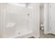 Clean, modern shower with built-in shelving and a view of the toilet through the doorway at 89 W Emily Gardens Dr, Selma, NC 27576