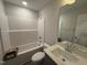 Clean bathroom with a shower over tub, white toilet, single vanity with mirror, and overhead lighting at 89 W Emily Gardens Dr, Selma, NC 27576