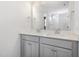 Bathroom vanity with dual sinks, gray cabinetry, and a large mirror at 89 W Emily Gardens Dr, Selma, NC 27576
