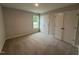 Bedroom with a window overlooking an exterior view, and closet with a bi-fold door at 89 W Emily Gardens Dr, Selma, NC 27576