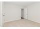 Comfortable bedroom with a closet, doorway, and soft neutral colored carpeting at 89 W Emily Gardens Dr, Selma, NC 27576