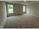 Light-filled bedroom featuring plush carpeting and large windows with outdoor views at 89 W Emily Gardens Dr, Selma, NC 27576