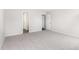 Spacious bedroom with neutral carpet, light walls, and a doorway leading to another room at 89 W Emily Gardens Dr, Selma, NC 27576