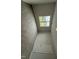 Comfortable bedroom with neutral carpeting and a view from the large window at 89 W Emily Gardens Dr, Selma, NC 27576