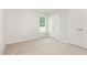Bright bedroom with natural light, closets, and soft neutral colored carpeting at 89 W Emily Gardens Dr, Selma, NC 27576