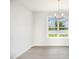 Dining area featuring wood-look floors, a white wall paint, chandelier, and natural light at 89 W Emily Gardens Dr, Selma, NC 27576