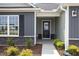 Inviting front entrance featuring well manicured landscaping and neutral siding at 89 W Emily Gardens Dr, Selma, NC 27576