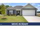 Charming single-story home boasts a well-manicured lawn and attached two-car garage at 89 W Emily Gardens Dr, Selma, NC 27576