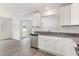 Bright kitchen features white cabinets, stainless steel appliances, and granite countertops at 89 W Emily Gardens Dr, Selma, NC 27576