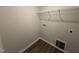 Convenient laundry room with a wire rack shelf and hookups for washer and dryer at 89 W Emily Gardens Dr, Selma, NC 27576
