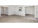 Spacious living room featuring wood-look floors, a white wall paint, and an open layout at 89 W Emily Gardens Dr, Selma, NC 27576