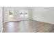 Bright living room featuring wood-look floors, a white wall paint, and natural light at 89 W Emily Gardens Dr, Selma, NC 27576