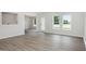 Open living area with new floors, white paint, and a view into dining room at 89 W Emily Gardens Dr, Selma, NC 27576