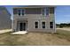 Rear exterior showcasing vinyl siding, double hung windows and sliding glass door at 9 W Emily Gardens Dr, Selma, NC 27576