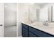 Bathroom with double vanity, navy blue cabinets, white countertop, and a large mirror at 9 W Emily Gardens Dr, Selma, NC 27576