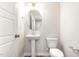 Elegant powder room features a pedestal sink, oval mirror, and wood-look flooring at 9 W Emily Gardens Dr, Selma, NC 27576