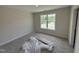 A bright and empty bedroom with new carpet, a large window, and an electrical outlet at 9 W Emily Gardens Dr, Selma, NC 27576