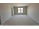 A sun-drenched bedroom with natural light from a large window overlooking the front yard at 9 W Emily Gardens Dr, Selma, NC 27576