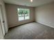 Bedroom with neutral carpet, a window offering natural light, and freshly painted, neutral walls at 9 W Emily Gardens Dr, Selma, NC 27576