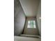 Cozy bedroom featuring neutral walls and gray carpet matched with natural light from a large window at 9 W Emily Gardens Dr, Selma, NC 27576